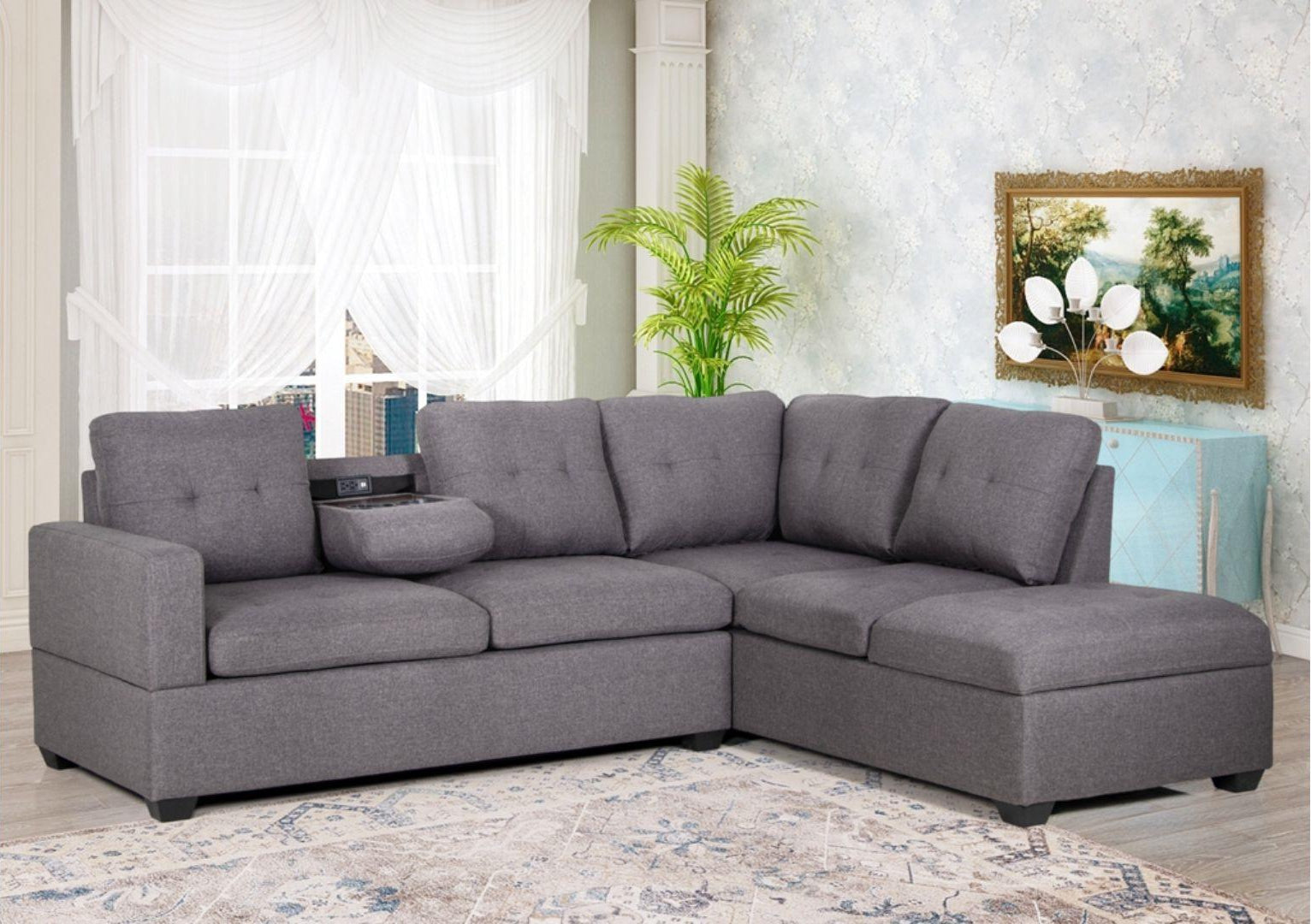 A gray fabric sectional sofa with a chaise on one end, integrated storage, and a drop-down console with cupholders.