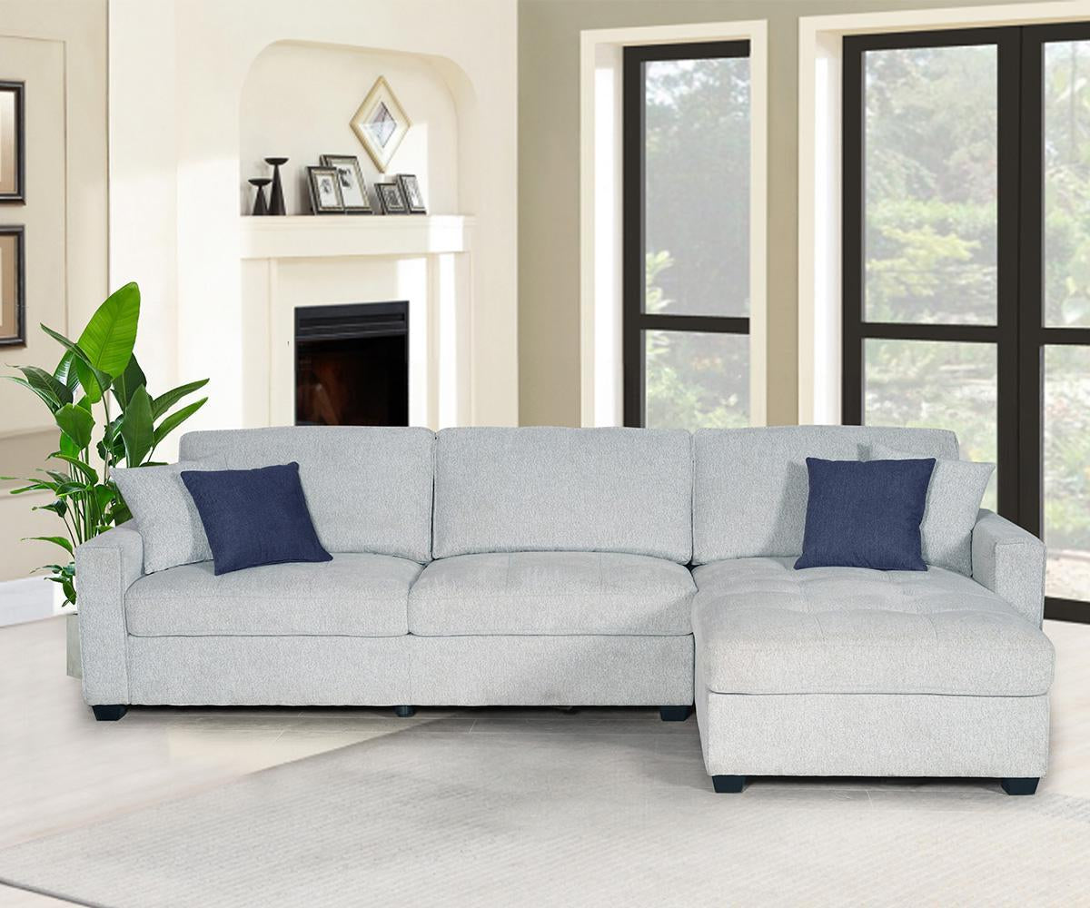 Gray sectional sofa with blue pillows in a living room setting.