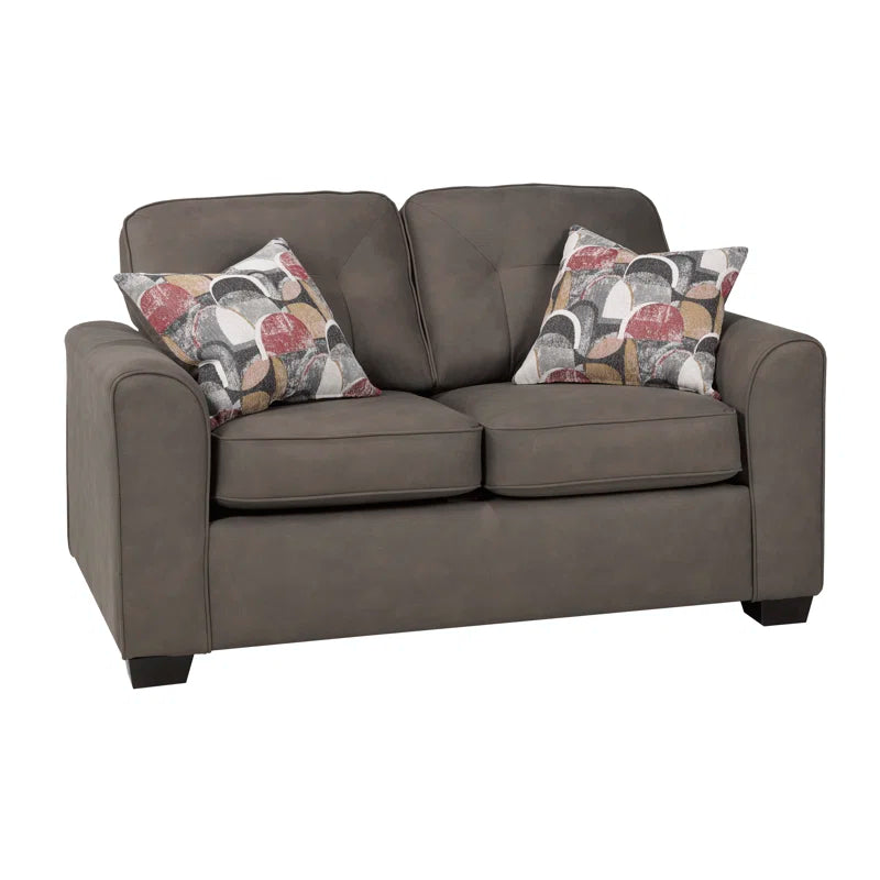 Mocha loveseat with patterned cushions on a white background