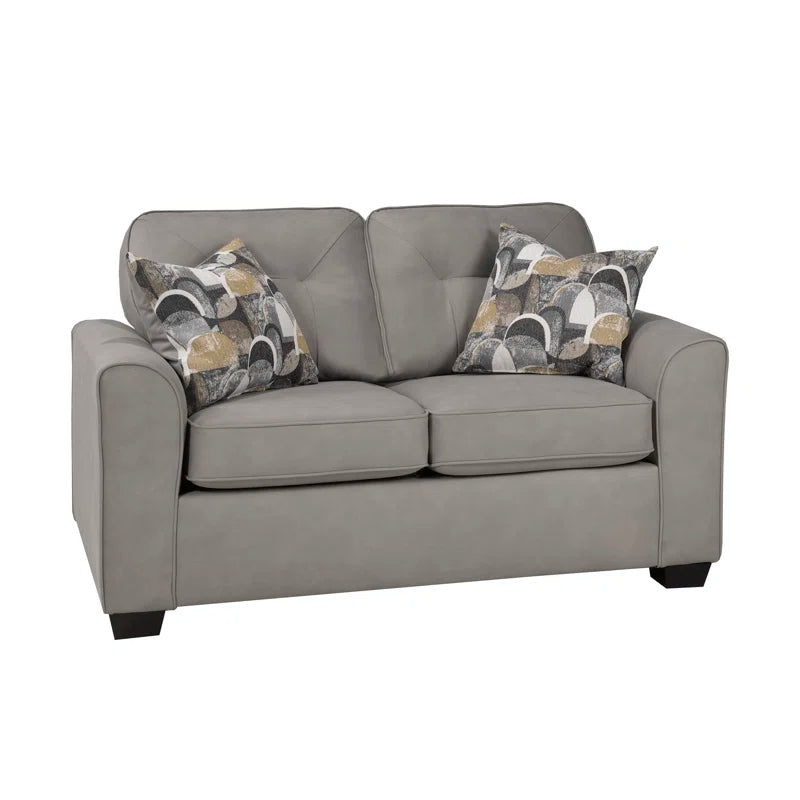 Slate loveseat with patterned cushions on a white background