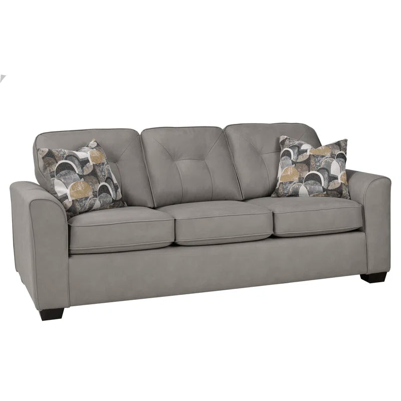 Slate sofa with patterned cushions on a white background