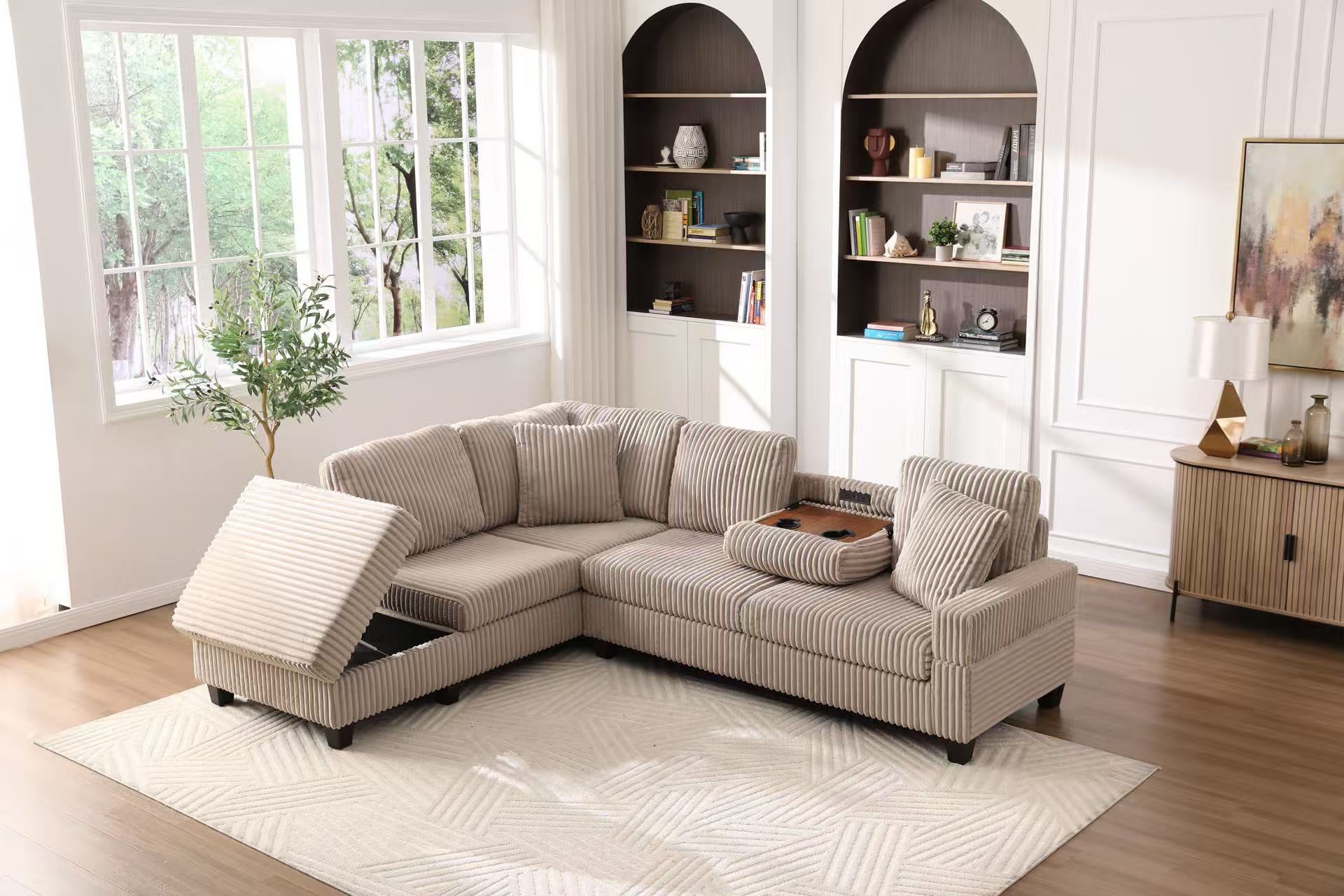 Beige sectional sofa in a living room with bookshelves and a window.
